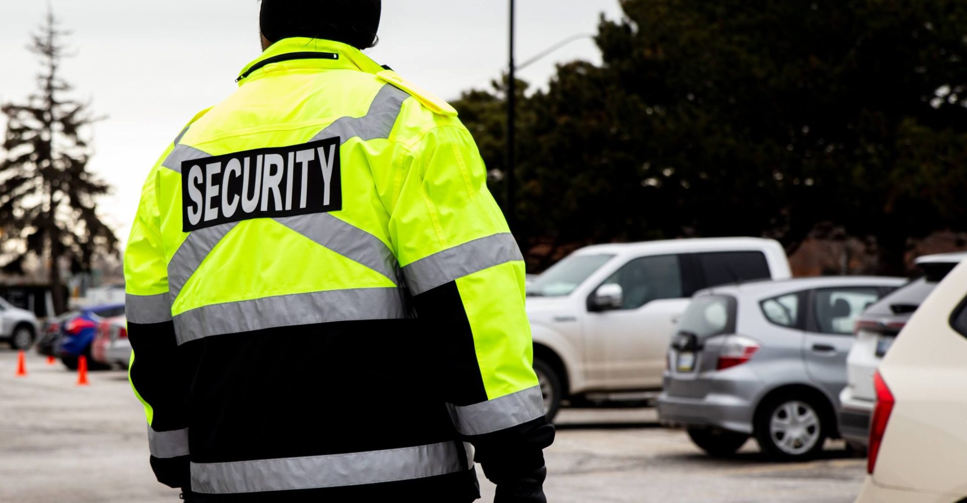 A man wearing a bright yellow jacket stands confidently, showcasing a vibrant and stylish outerwear choice.